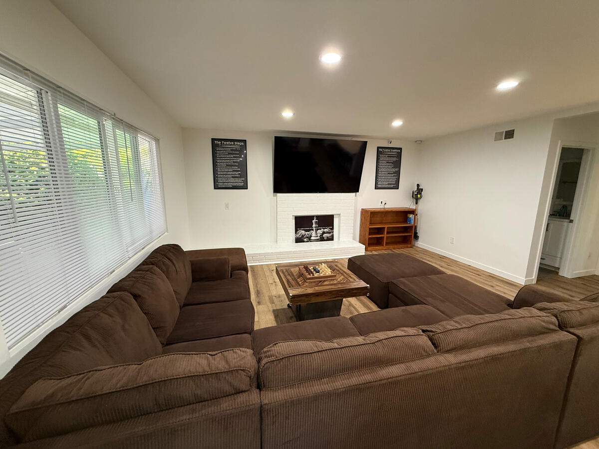 Living room at Clean Quarters Inc. Foundation House showing our 85 inch Roku TV