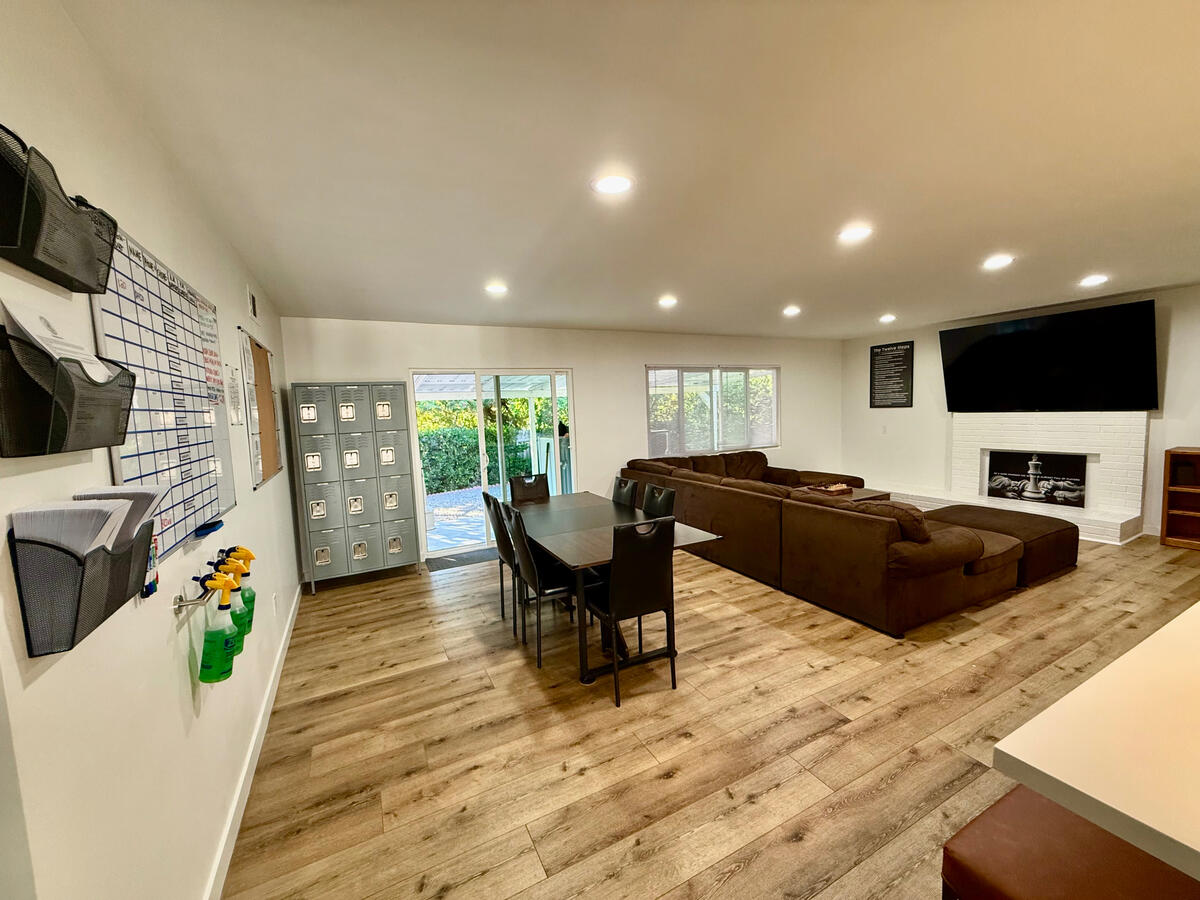 Lockers, chore board dining room and living room view at Clean Quarters Inc. “Foundation House”
