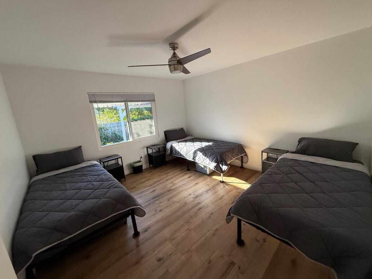 Courage room at Clean Quarters Inc. Foundation House with three twin XL (memory foam mattresses) and charging nightstands