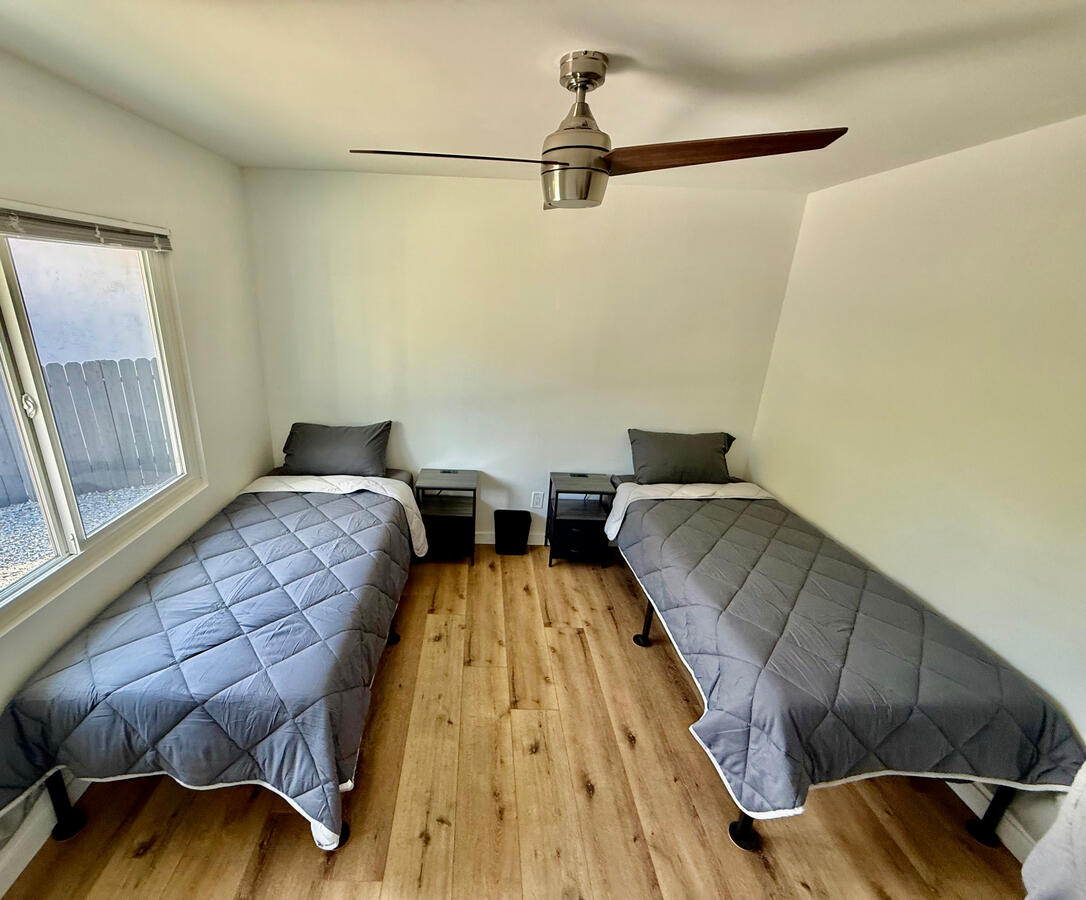 “Integrity Room” with two beds, memory foam mattresses, and charging nightstands